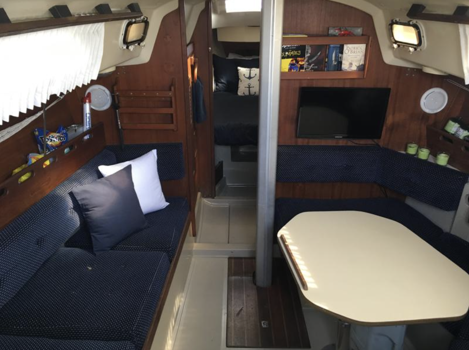 The spacious main cabin interior shows the boat's impressive volume for a 30-footer. The dinette configuration replaced the original double-settee layout in 1980, trading some storage space for easier movement through the boat. Photo courtesy of SailboatListings.com